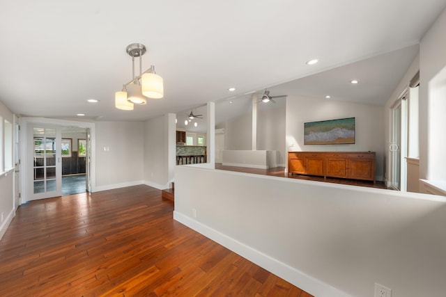 unfurnished living room featuring dark hardwood / wood-style floors, ceiling fan, and lofted ceiling