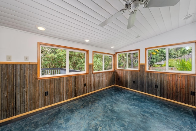 carpeted spare room featuring ceiling fan, wood walls, lofted ceiling, and wood ceiling