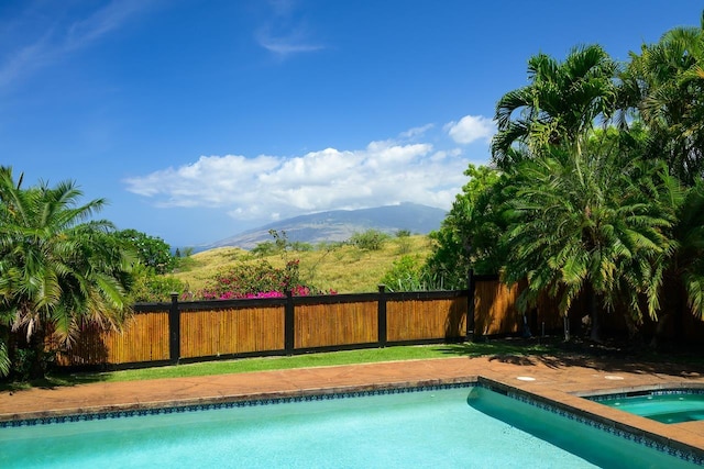 view of pool with a mountain view and a jacuzzi