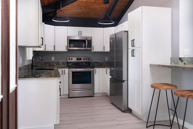 kitchen with wood ceiling, vaulted ceiling with beams, white cabinetry, and stainless steel appliances