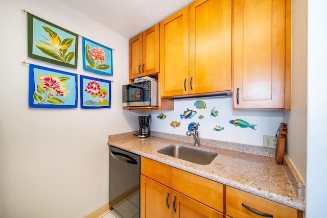 kitchen with light stone countertops, black dishwasher, and sink