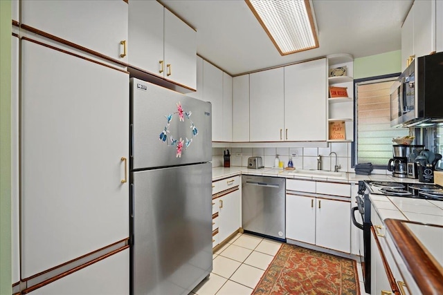 2661 Kekaa Dr Unit L-202, Lahaina, HI 96761 - kitchen featuring appliances with stainless steel finishes, tile counters, a sink, and open shelves