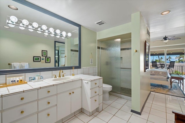 2661 Kekaa Dr Unit L-202, Lahaina, HI 96761 - bathroom featuring vanity, toilet, tile patterned floors, ceiling fan, and a shower stall