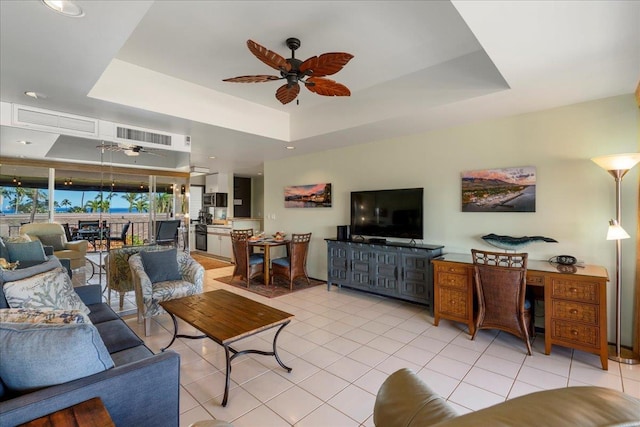 2661 Kekaa Dr Unit L-202, Lahaina, HI 96761 - living area featuring ceiling fan, a tray ceiling, and light tile patterned flooring
