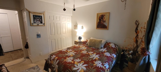 bedroom featuring tile patterned flooring and a closet