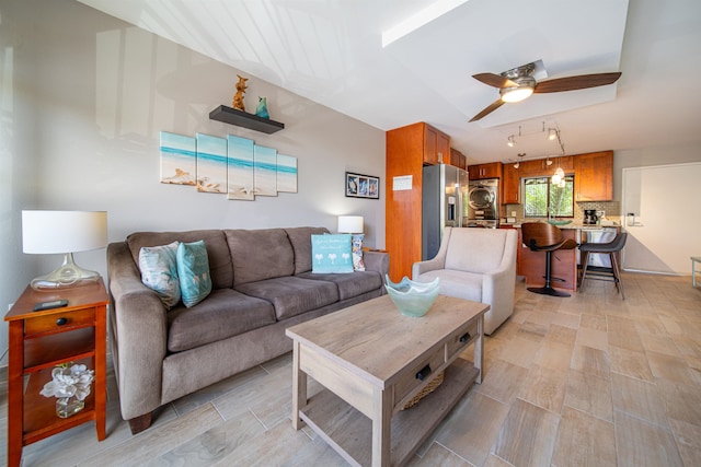 living room featuring washer / clothes dryer and ceiling fan