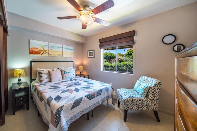 tiled bedroom featuring ceiling fan