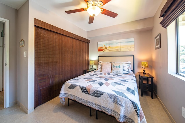 tiled bedroom with ceiling fan