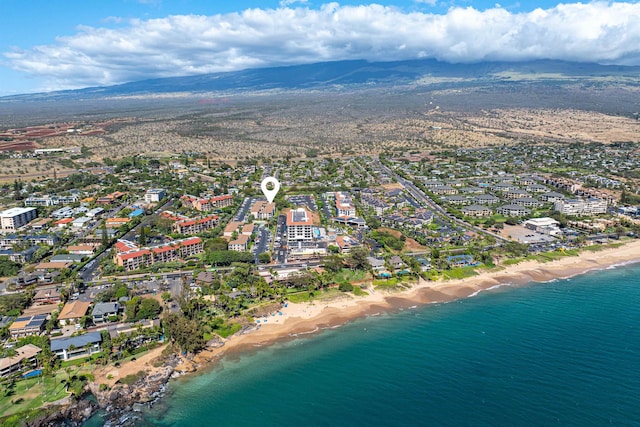 drone / aerial view featuring a water view and a beach view