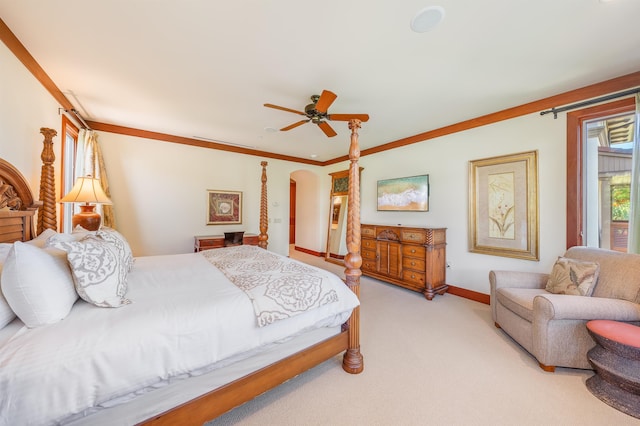 carpeted bedroom featuring ceiling fan and ornamental molding