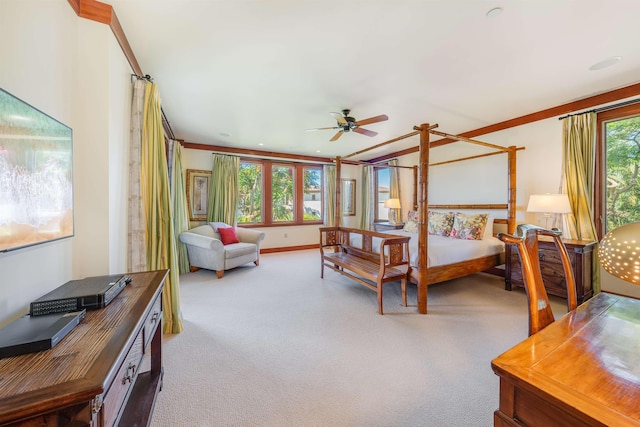 carpeted bedroom featuring ceiling fan and crown molding