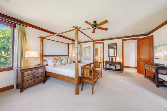 carpeted bedroom with ceiling fan and ornamental molding