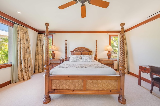 bedroom with ceiling fan, ornamental molding, and light colored carpet