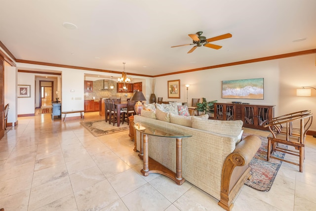 tiled living room with ceiling fan with notable chandelier and ornamental molding