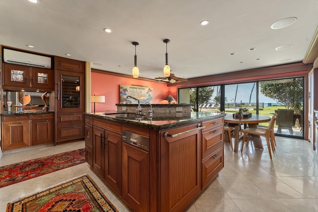 kitchen with decorative light fixtures, an AC wall unit, a sink, dark stone countertops, and dishwasher