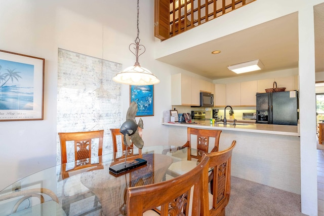 carpeted dining space with sink