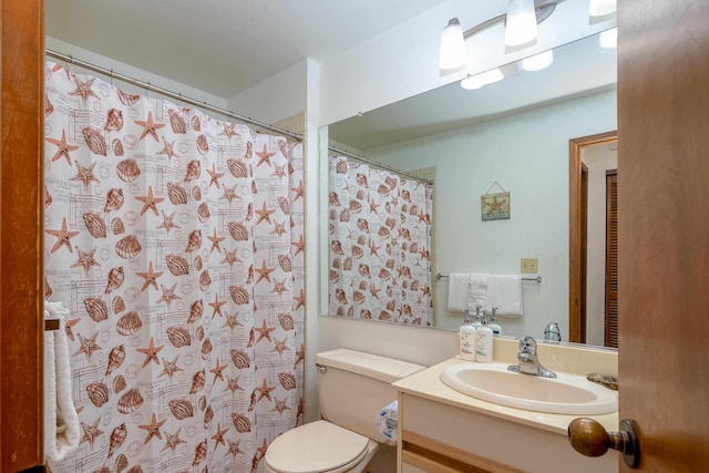 bathroom featuring vanity and toilet