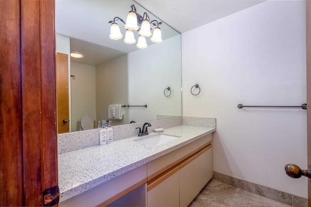 bathroom featuring tile patterned flooring, vanity, and toilet