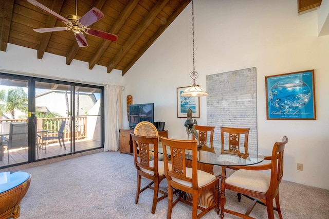 dining area with carpet flooring, ceiling fan, a healthy amount of sunlight, and high vaulted ceiling