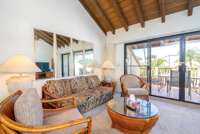 living room with beam ceiling, carpet floors, a wealth of natural light, and wooden ceiling