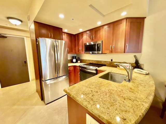 kitchen with appliances with stainless steel finishes, light tile patterned floors, sink, kitchen peninsula, and light stone counters