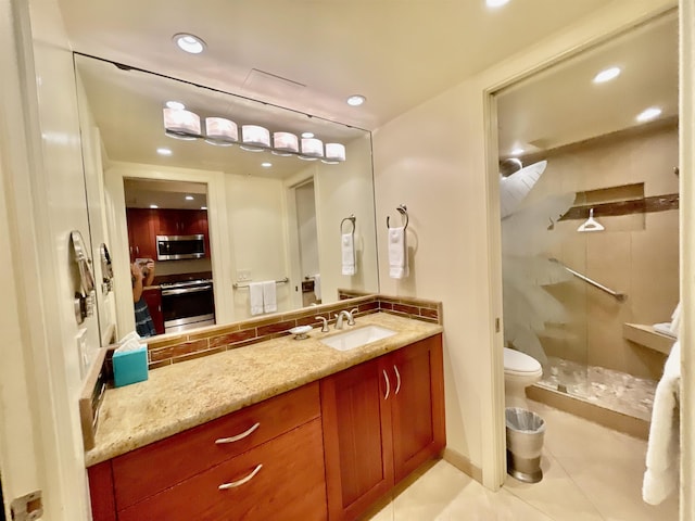 bathroom with tile patterned floors, walk in shower, toilet, and vanity