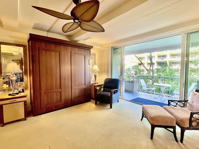 sitting room featuring light carpet and ceiling fan