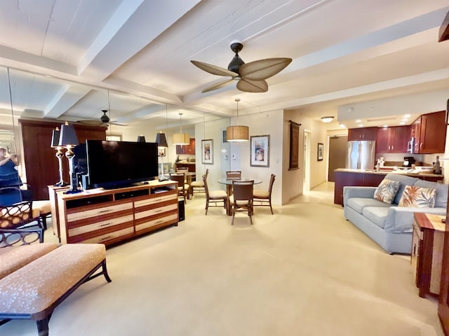 carpeted living room with beamed ceiling and ceiling fan