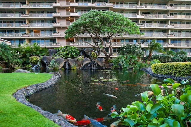 view of property's community with a small pond