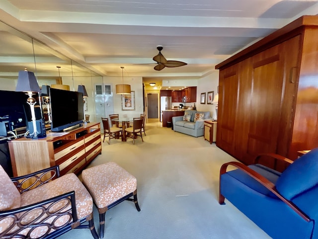 living room featuring ceiling fan, beam ceiling, and light carpet