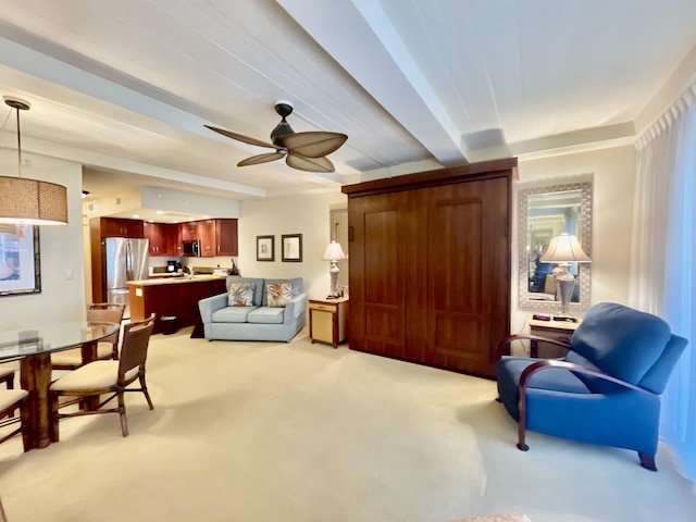 living room featuring ceiling fan, carpet, and beam ceiling