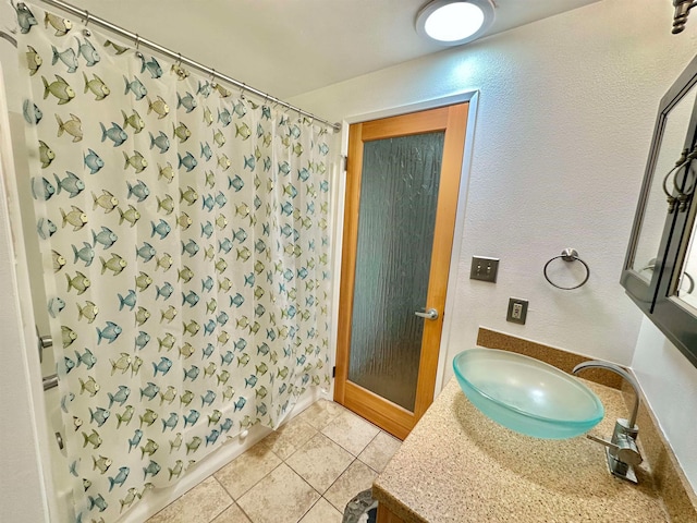 bathroom featuring vanity, walk in shower, and tile patterned flooring