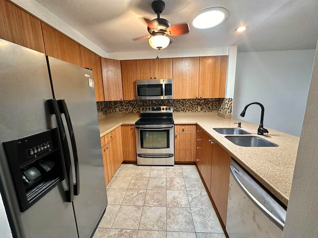 kitchen with kitchen peninsula, backsplash, sink, appliances with stainless steel finishes, and ceiling fan