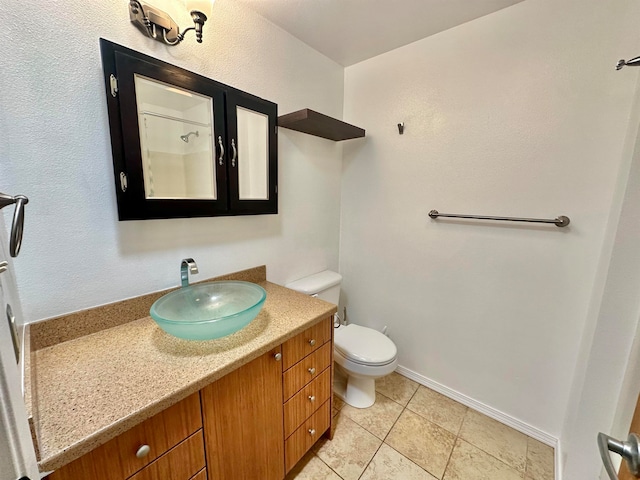 bathroom with vanity, toilet, and tile patterned floors