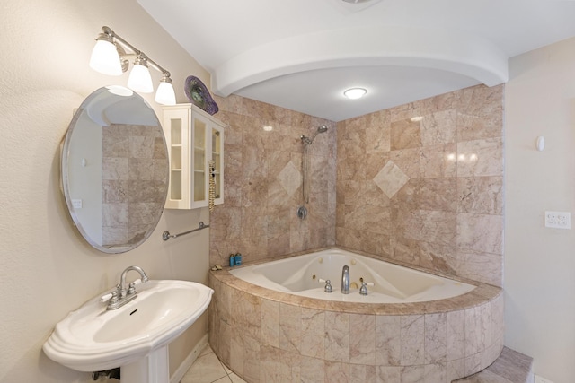 bathroom featuring a sink and tiled shower / bath