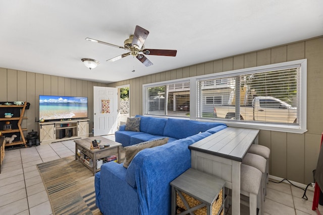 living room featuring a ceiling fan and light tile patterned floors