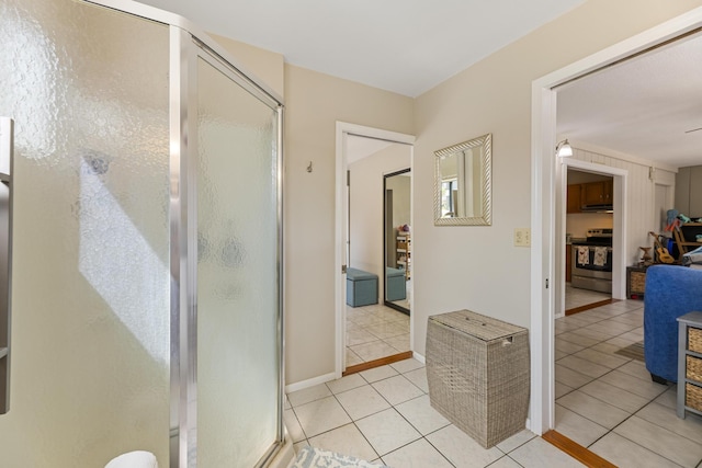 full bathroom featuring tile patterned flooring and a shower stall