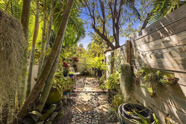 view of yard with a deck and fence