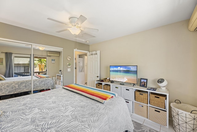 bedroom with a wall mounted AC, a closet, and a ceiling fan