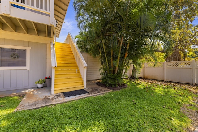 view of yard featuring stairs and fence