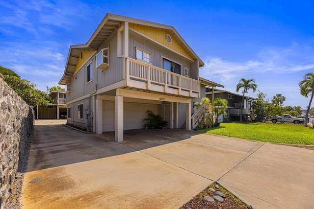 view of front of house featuring a garage, a front yard, and driveway