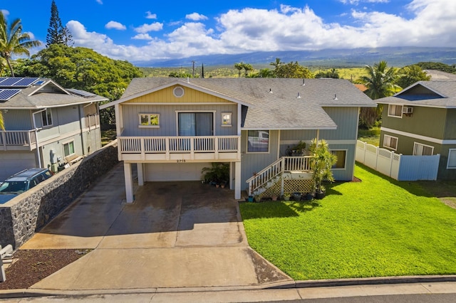 view of front of home featuring a garage, fence, concrete driveway, roof with shingles, and a front lawn