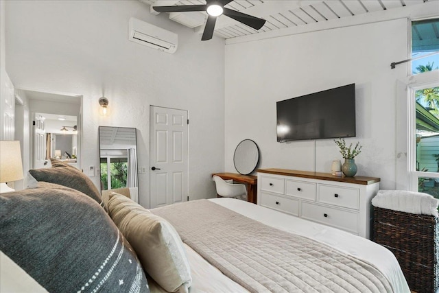 bedroom featuring an AC wall unit, beam ceiling, a high ceiling, and ceiling fan