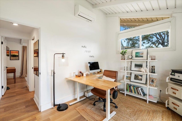 office area featuring an AC wall unit, wood finished floors, beamed ceiling, baseboards, and recessed lighting