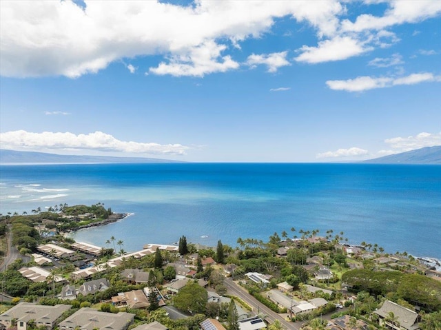 aerial view of property's location featuring a nearby body of water and nearby suburban area