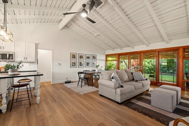 living room with high vaulted ceiling, a ceiling fan, baseboards, light wood finished floors, and wood ceiling