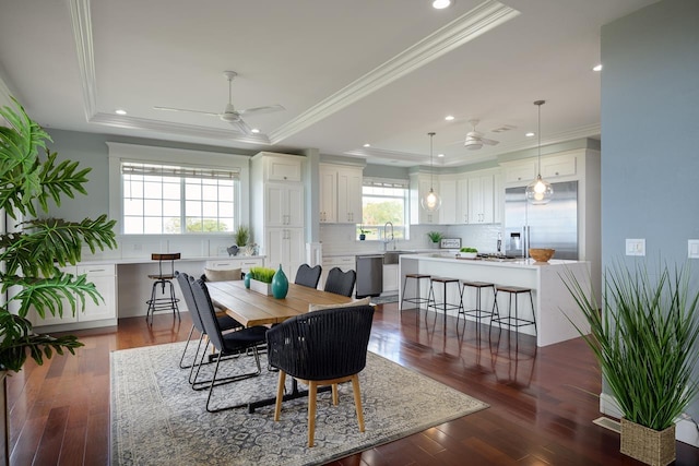 dining area featuring ornamental molding, a tray ceiling, recessed lighting, and ceiling fan