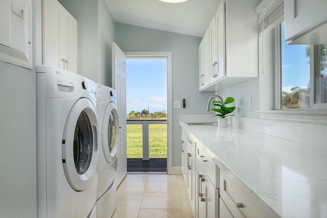 laundry room with separate washer and dryer, cabinet space, a sink, and plenty of natural light