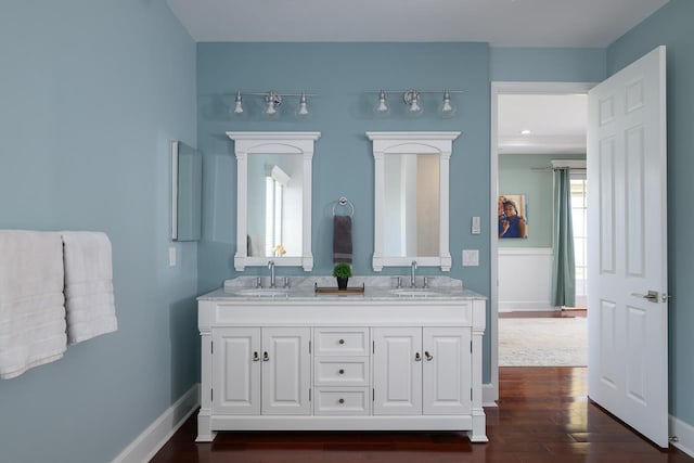 full bathroom with a wealth of natural light, baseboards, and a sink