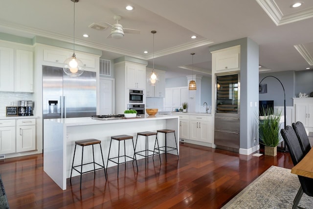 kitchen featuring decorative backsplash, stainless steel built in refrigerator, a ceiling fan, and dark wood-style floors